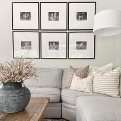 a living room filled with lots of furniture and pictures on the wall above it's coffee table