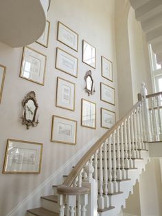 an image of a staircase with pictures on the wall and stairs in front of it