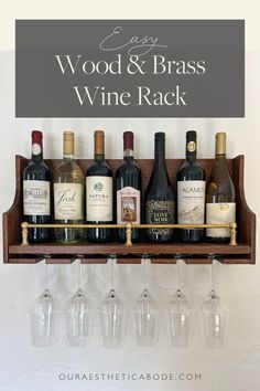 several wine glasses are lined up on a shelf with the words easy wood and brass wine rack