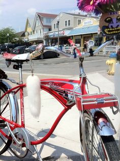 a red bicycle parked next to a fire hydrant