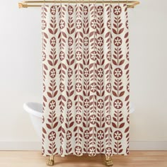 a brown and white shower curtain with an abstract design in the center on a wooden floor