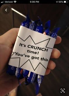 someone is holding up a candy bar wrapper that says it's crunch time you've got this