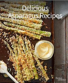 cooked asparagus on a baking sheet with butter and seasoning next to it