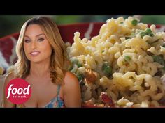 a woman standing in front of a bowl of pasta and vegetables with the words food network