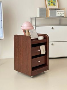 a desk with a lamp, phone and other items on it