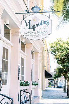 the sign for magnotas lunch and dinner is hanging from the side of the building