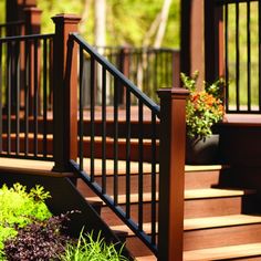 a wooden deck with railing and planters on it