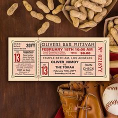 a baseball ticket sitting on top of a wooden table next to a glove and ball