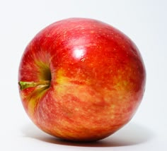 an apple sitting on top of a white table