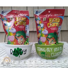 two bags of lucky charms cereal sit next to a bowl