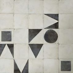 an abstract tile design with black and white geometric shapes on the outside, including two circles