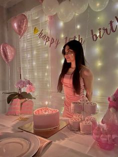 a woman standing in front of a birthday cake