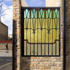 a stained glass window on the side of a brick building