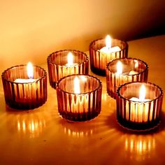 five candles are lit on a table