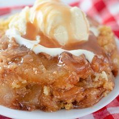 a piece of apple pie on a plate with ice cream and caramel drizzle