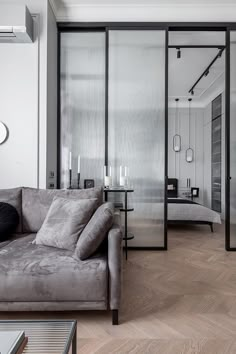 a living room filled with furniture and mirrors