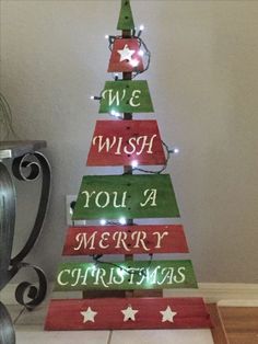 a wooden christmas tree with lights on it