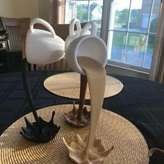 two vases sitting on top of straw hats