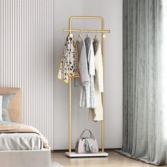 a clothes rack in the corner of a bedroom