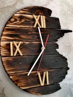 a clock made out of wood with roman numerals on the face and hands