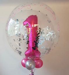 a pink number one balloon attached to a wall