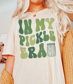 If you're a pickle lover, then you need this "In My Pickle Era" t-shirt in your life! This tee is as comfortable as it is stylish. Whether you're running errands or hanging out with friends, this shirt is sure to turn heads and spark conversations. DETAILS * Bella + Canvas Unisex Premium T-Shirt  * Soft and lightweight  * 100% combed and ring-spun cotton  * Athletic Heather is 90% combed and ring-spun cotton, 10% polyester * Design is printed using DTG technology which uses high-quality water-ba Pickle Crafts, Pickle Festival, Pickle Jar, Pickle Lover Gifts, Pickle Outfit, Pickle Accessories