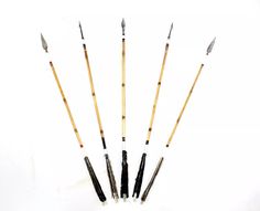 five different types of paintbrushes lined up in a row on a white surface