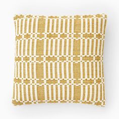 a yellow and white pillow on a white background