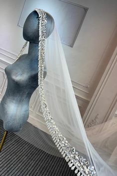 a mannequin wearing a veil with crystal beads