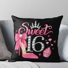 a pillow that says sweet 16 with pink shoes and cupcakes on the front