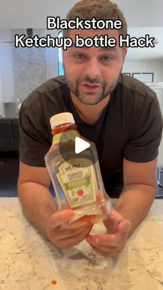 a man is holding a bottle of ketchup and posing for a photo with the caption blackstone ketchup bottle hack