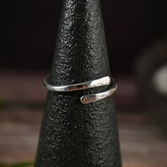 Adjustable hammered sterling silver wrap ring for everyday wear. Feel like royalty without the extravagance. Polished and shined to a mirror finish, this hammered ring is simple and elegant. Wear it with a casual outfit, or dress it up for a night out. Made in small batches, these adjustable rings make wonderful gifts that will last a lifetime. I create these bands from 14 gauge sterling silver round wire. I make them durable by hammering, then polish them until I'm satisfied with the quality. R Silver Wrap Ring, Elegant Wear, Carnelian Jewelry, Jasper Jewelry, Hammered Ring, Hammered Sterling Silver, Wrap Ring, Quartz Jewelry, Detailed Ring