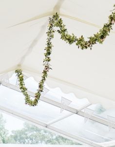 wedding decorations hanging from the ceiling in a tent