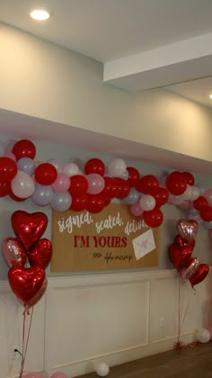 red and white balloons in the shape of hearts are on display at a valentine's day party