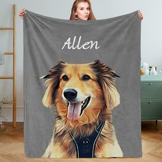 a woman holding up a blanket with an image of a golden retriever on it