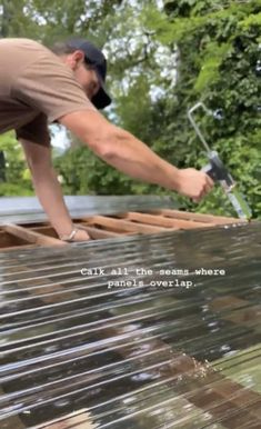 a man working on the roof of a house