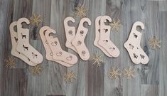 five wooden christmas stockings are lined up on the floor