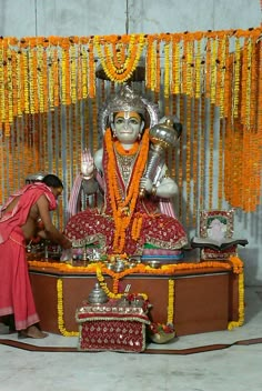 an idol is being placed in front of a shrine