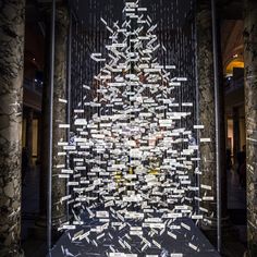 an art installation made out of cut up pieces of paper on display in a building