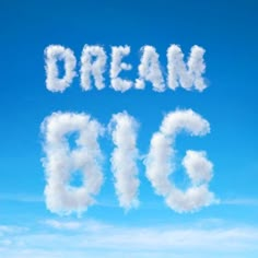 the words dream big written in clouds against a blue sky