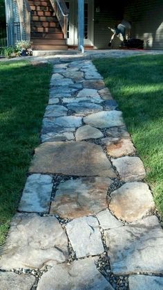 a stone path in front of a house