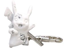 a keychain with a white rabbit and two baby rabbits on it's back