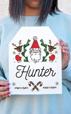 a woman holding up a sign with the word hunter on it in front of her face