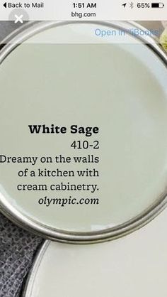 white sage on the walls of a kitchen with cream cabinetry in front of it