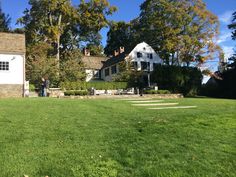 a white house sitting on top of a lush green field