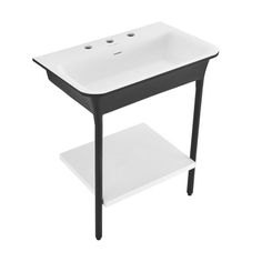 a white sink sitting on top of a wooden shelf next to a black and white stand