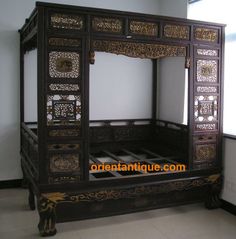 an ornate wooden bed frame sitting in a room