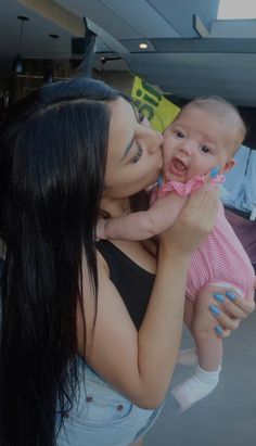 a woman holding a baby in her arms