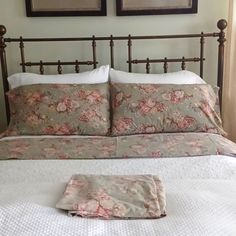 a bed with two framed pictures on the wall above it