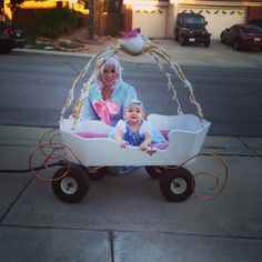 a woman and baby in a wagon on the street